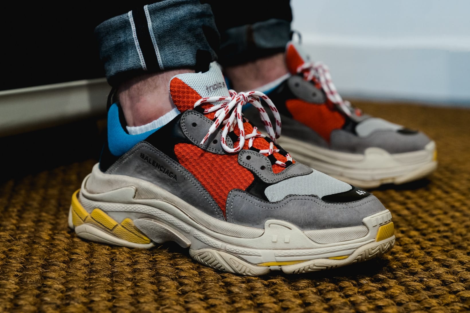 The Balenciaga Triple S Black White Red worn by the young